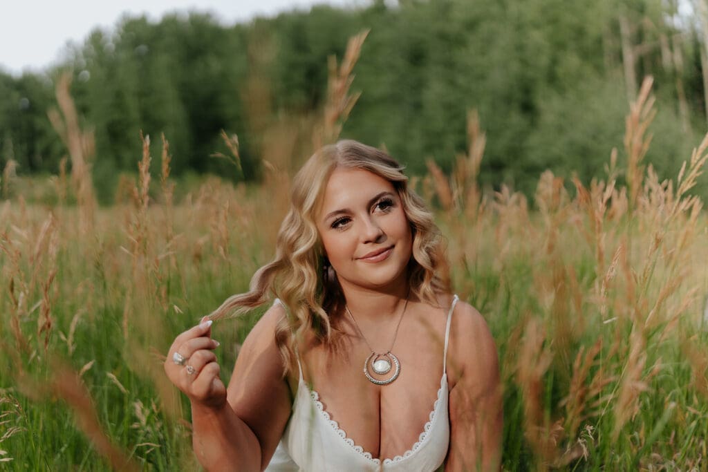 Senior girl smiling in a field of wildflowers in southwestern Colorado